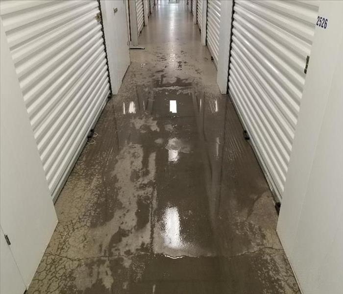 Flooded hallway in a storage facility.