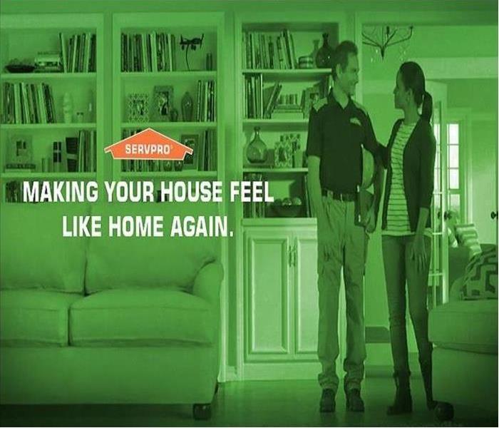 SERVPRO Technician with Customer in their home.